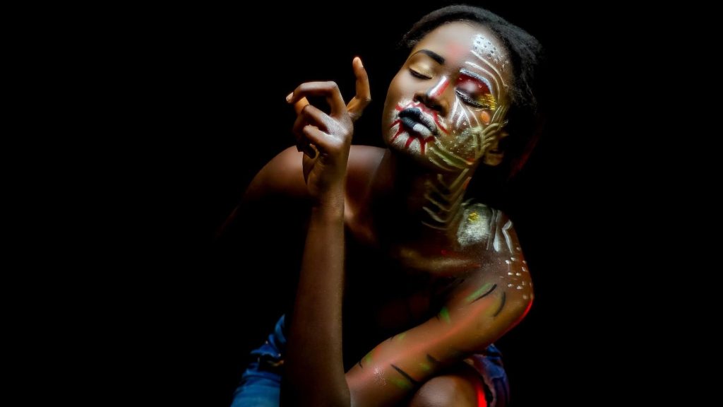 A woman adorned with intricate body paint, showcasing artistic expression and creativity